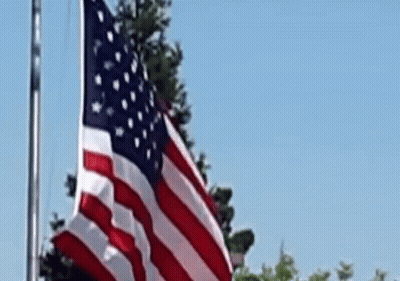 American Flag Waving Against Blue Sky GIF