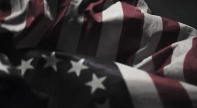 American Flag Waving In Wind In Dark Room GIF
