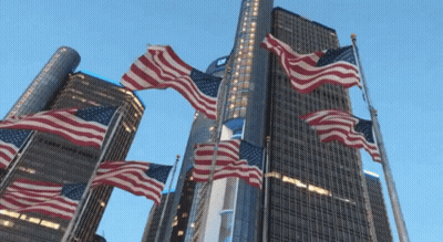 American Flags Flying In Front Of Tall Building GIF