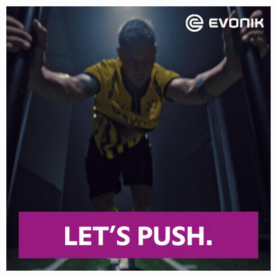 An Ad For Evonik Shows A Man In A Yellow And Black Uniform GIF