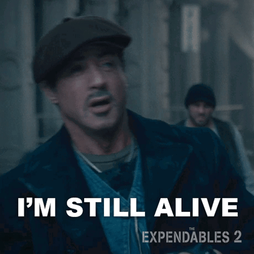 An Ad For Expendables 2 Shows A Man Wearing A Hat GIF