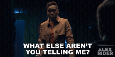 An Advertisement For Alex Rider Shows A Woman In A Trench Coat Talking To A Man GIF