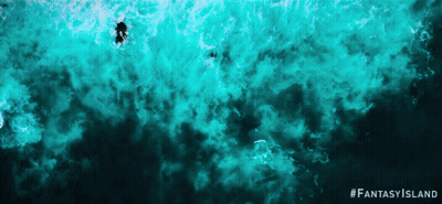 An Advertisement For Fantasy Island Shows A Person Swimming In The Water GIF