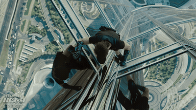 An Advertisement For Mission Impossible Shows A Man Hanging From A Building GIF