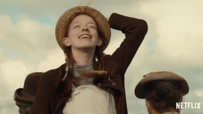 An Advertisement For Netflix Shows A Girl In A Straw Hat Laughing GIF