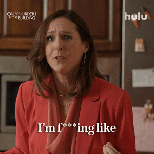 An Advertisement For Only Murders In The Building Shows A Woman In A Red Jacket Saying I 'M F *** Ing Like GIF