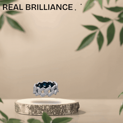 An Advertisement For Real Brilliance Shows A Ring On A Wooden Podium GIF