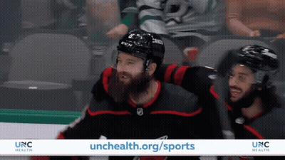 An Advertisement For Unc Health Shows Hockey Players On The Ice GIF