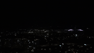 An Aerial View Of A City At Night With A Lot Of Lights On GIF
