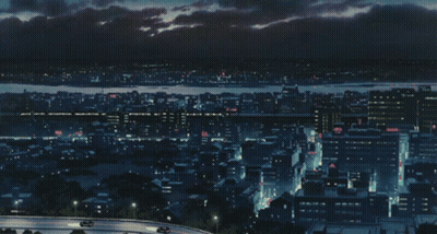 An Aerial View Of A City At Night With Cars On The Road GIF