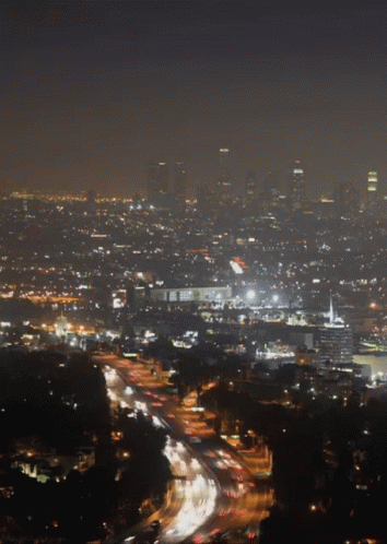 An Aerial View Of A City At Night With Lots Of Lights GIF