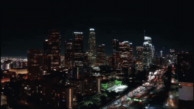 An Aerial View Of A City Skyline At Night With A Few Buildings Lit Up Including One That Says Chase GIF