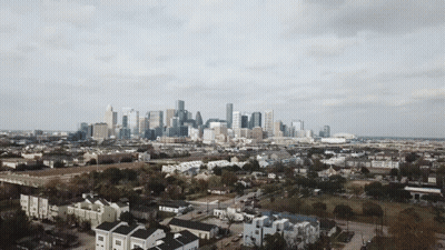 An Aerial View Of A City Skyline With A Lot Of Buildings GIF