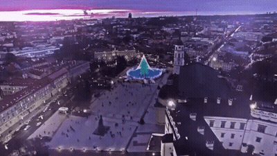 An Aerial View Of A City With A Christmas Tree In The Center GIF