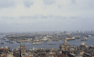 An Aerial View Of A City With A Clock Tower In The Middle Of The Water GIF