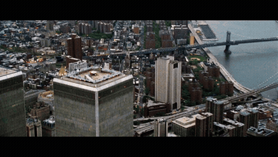 An Aerial View Of A City With A Helicopter On Top Of One Of The Buildings GIF