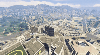 An Aerial View Of A City With A Large Building With The Letter G On The Roof GIF