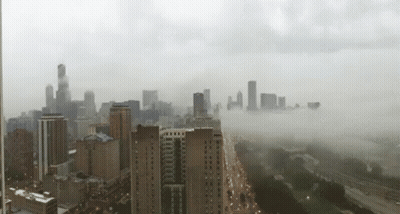 An Aerial View Of A City With A Lot Of Buildings GIF