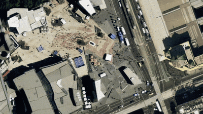 An Aerial View Of A City With A Lot Of Buildings And Streets GIF