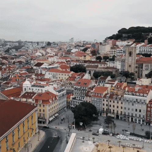 An Aerial View Of A City With A Lot Of Buildings GIF