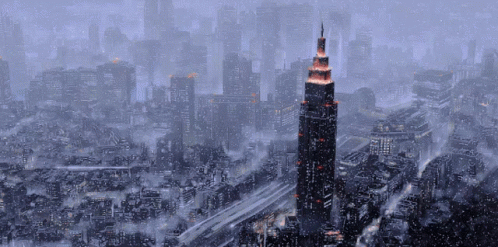 An Aerial View Of A City With A Very Tall Building In The Middle GIF