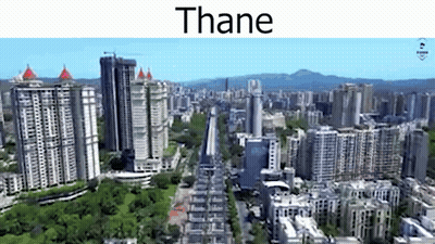 An Aerial View Of A City With Lots Of Tall Buildings And Trees GIF