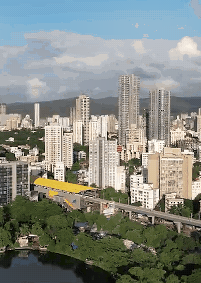 An Aerial View Of A City With Tall Buildings And Trees GIF