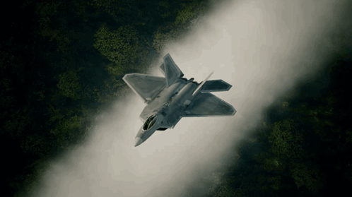 An Aerial View Of A Fighter Jet Flying Through The Air GIF