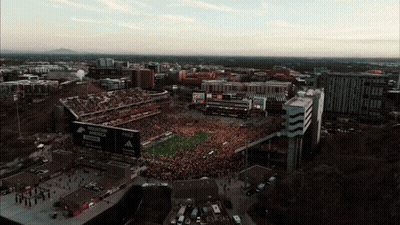 An Aerial View Of A Football Stadium With A Mountain Dew Billboard GIF