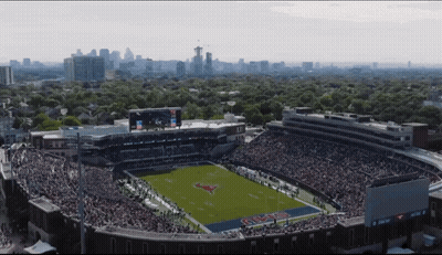 An Aerial View Of A Football Stadium With A Pepsi Ad On The Scoreboard GIF