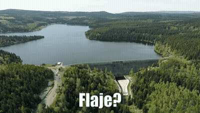 An Aerial View Of A Lake Surrounded By Trees With The Words Flaje Written Below It GIF