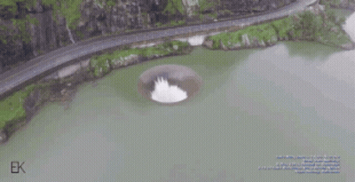 An Aerial View Of A Lake With A Hole In The Middle Of It GIF