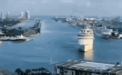 An Aerial View Of A Large Body Of Water Surrounded By Buildings GIF