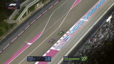 An Aerial View Of A Race Track With The Numbers 10 And 27 On The Screen GIF