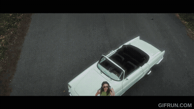 An Aerial View Of A Woman In A White Convertible With Gifrun.com Written Below It GIF