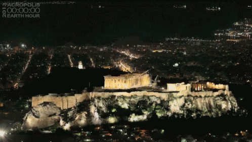 An Aerial View Of The Acropolis At Night With The Words #Acropolis 00:00:00 Nearth Hour On The Bottom GIF