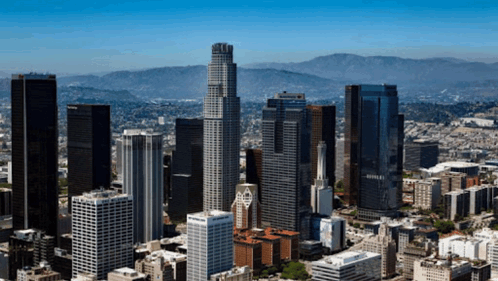 An Aerial View Of The City Of Los Angeles With A Few Mountains In The Background GIF