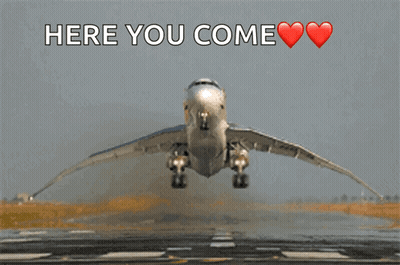 An Airplane Is Taking Off From A Runway And The Words Here You Come Are Above It GIF