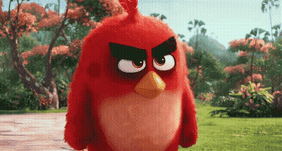 An Angry Bird From The Movie Angry Birds Is Standing In The Grass GIF