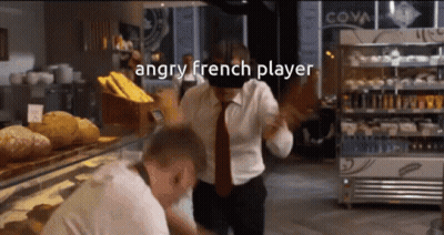 An Angry French Player Is Standing In Front Of A Display Case Of Bread GIF