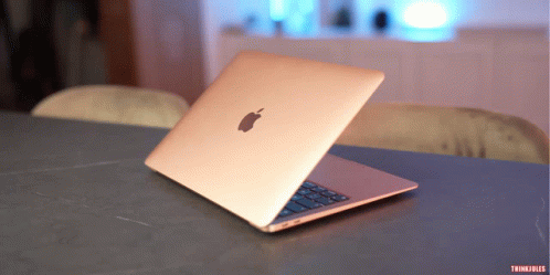 An Apple Laptop Sits Open On A Table With Thinkfiles Written On The Bottom GIF