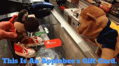 An Applebee 'S Gift Card Is On A Glass Display Case GIF