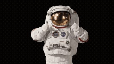 An Astronaut Is Giving A Thumbs Up Sign While Wearing A Nasa Space Suit . GIF