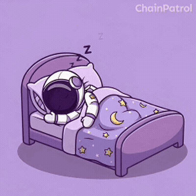 An Astronaut Is Sleeping In A Bed With A Purple Blanket GIF