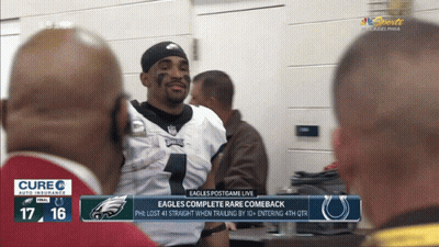 An Eagles Football Player Is Talking To A Group Of Men GIF