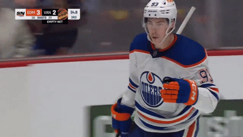 An Edmonton Oilers Hockey Player Runs On The Ice GIF