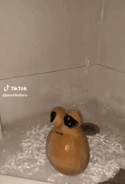 An Egg Is Floating In A Bathtub With A Hole In It . GIF