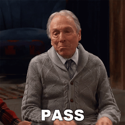 An Elderly Man In A Grey Sweater And Tie Is Saying Pass GIF