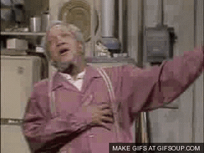 An Elderly Man In A Pink Jacket Is Standing In Front Of A Refrigerator With His Arms Outstretched . GIF