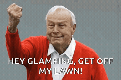 An Elderly Man In A Red Sweater Is Making A Funny Face With His Fist In The Air . GIF